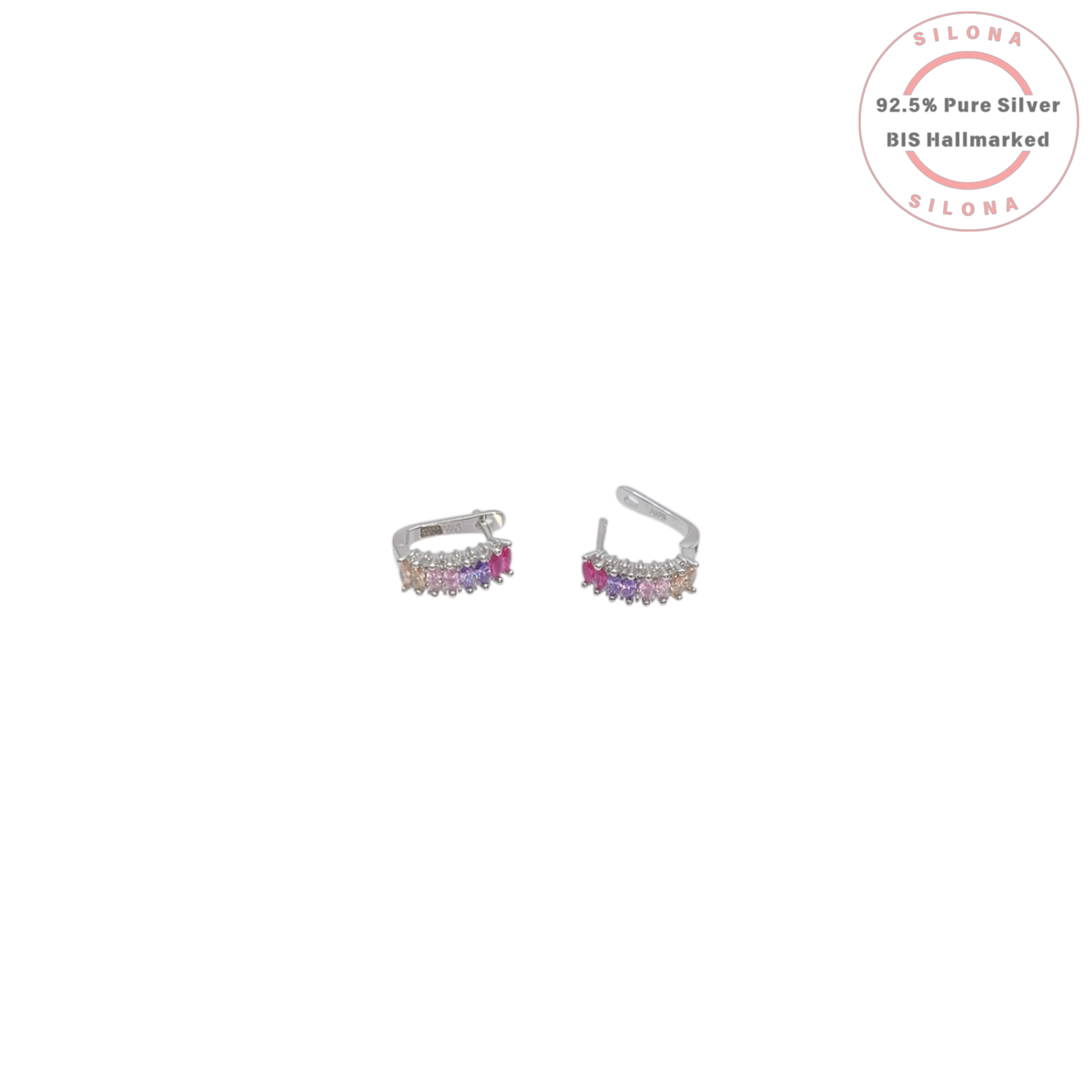 A pair of Silona silver huggie earrings with a vertical gradient of baguette-cut gemstones in shades of pink, purple, and champagne, on a white background.
