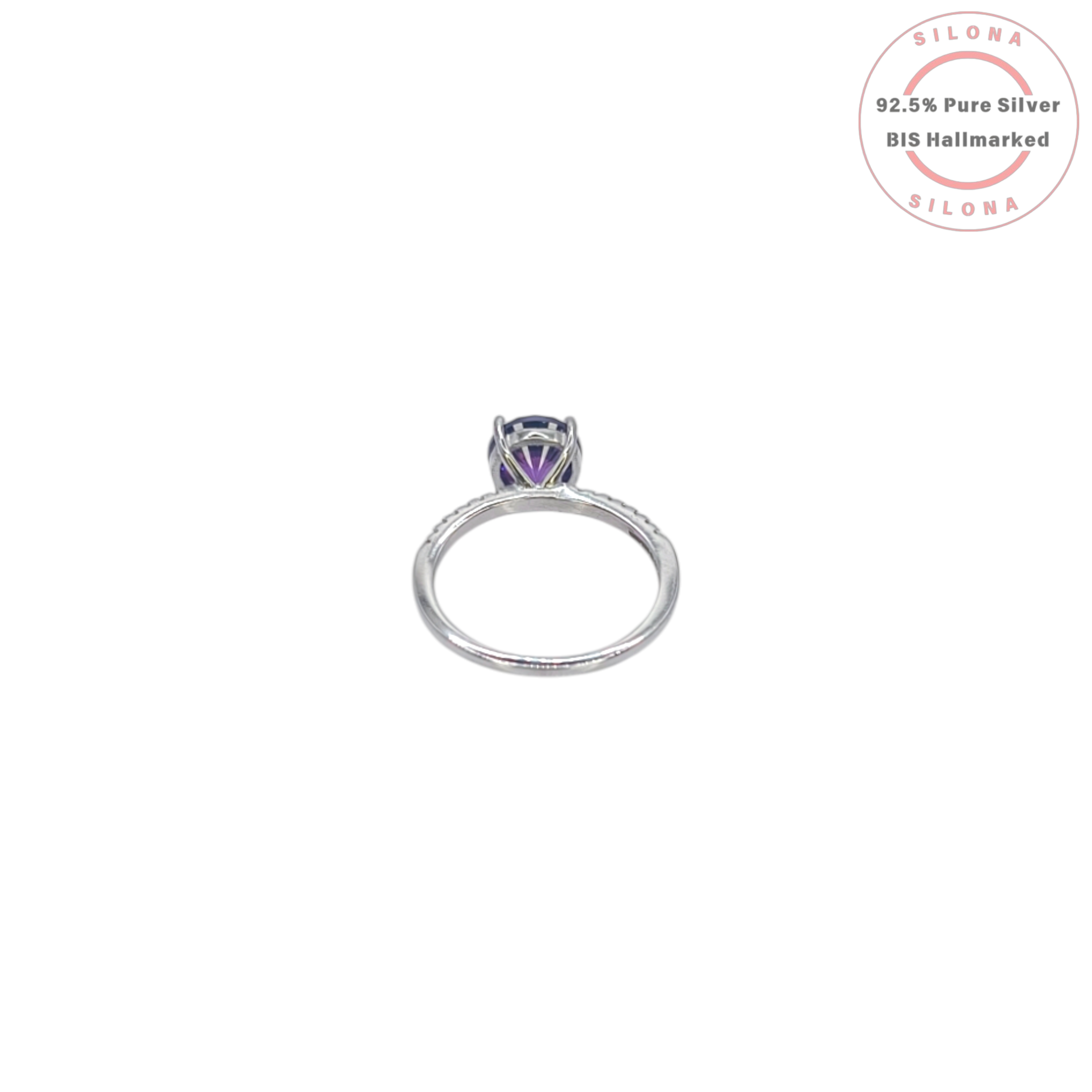 A classic solitaire ring crafted in 92.5 silver, featuring a large, round, deep purple center stone with pavé-set cubic zirconia on the band, shown on a white background.