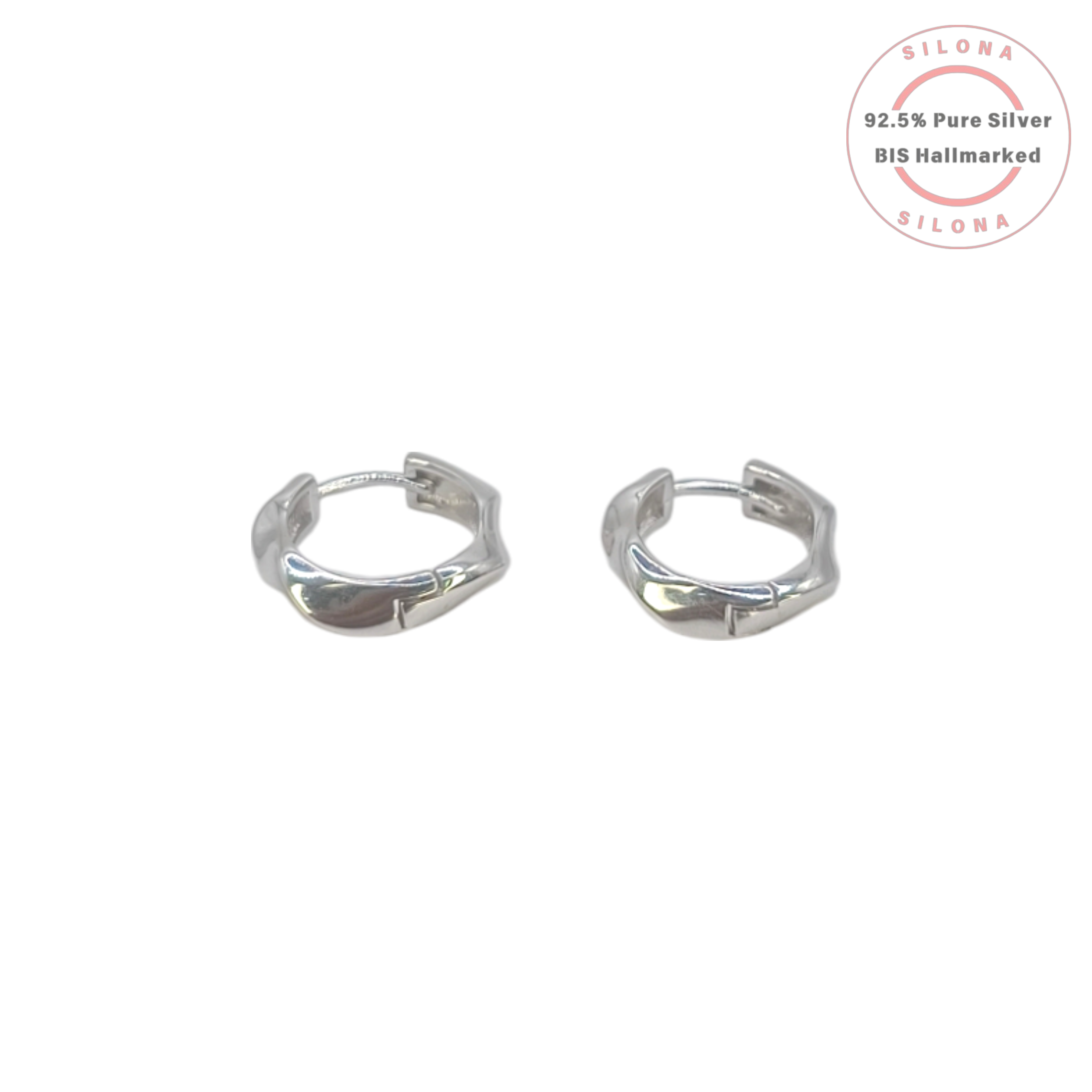 A pair of modern sculptural silver huggie earrings with a subtle twist design on a clean white background.