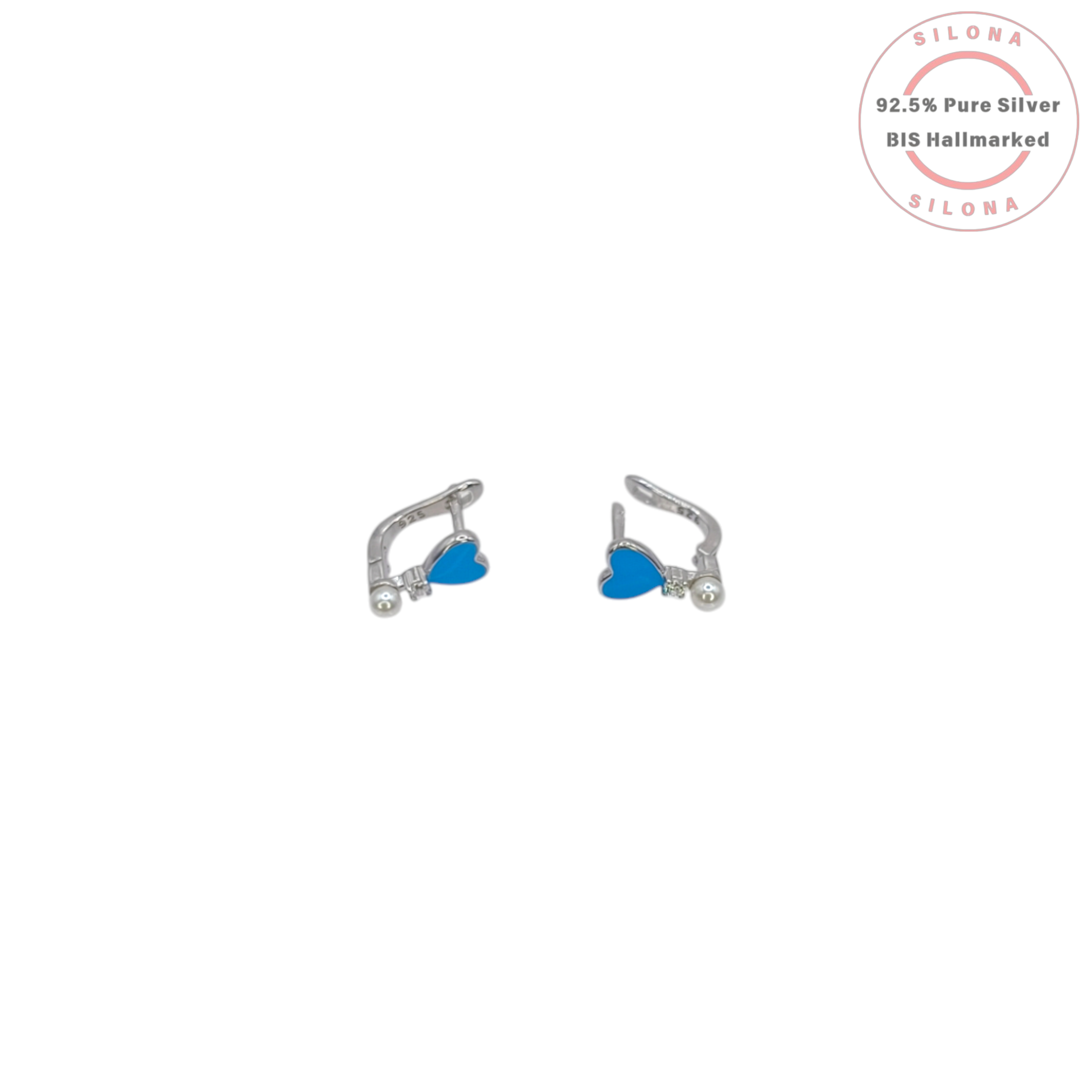 Pair of Silona silver huggie earrings featuring a bright blue enamel heart, pavé cubic zirconia, and a single white pearl drop, on a white background.
