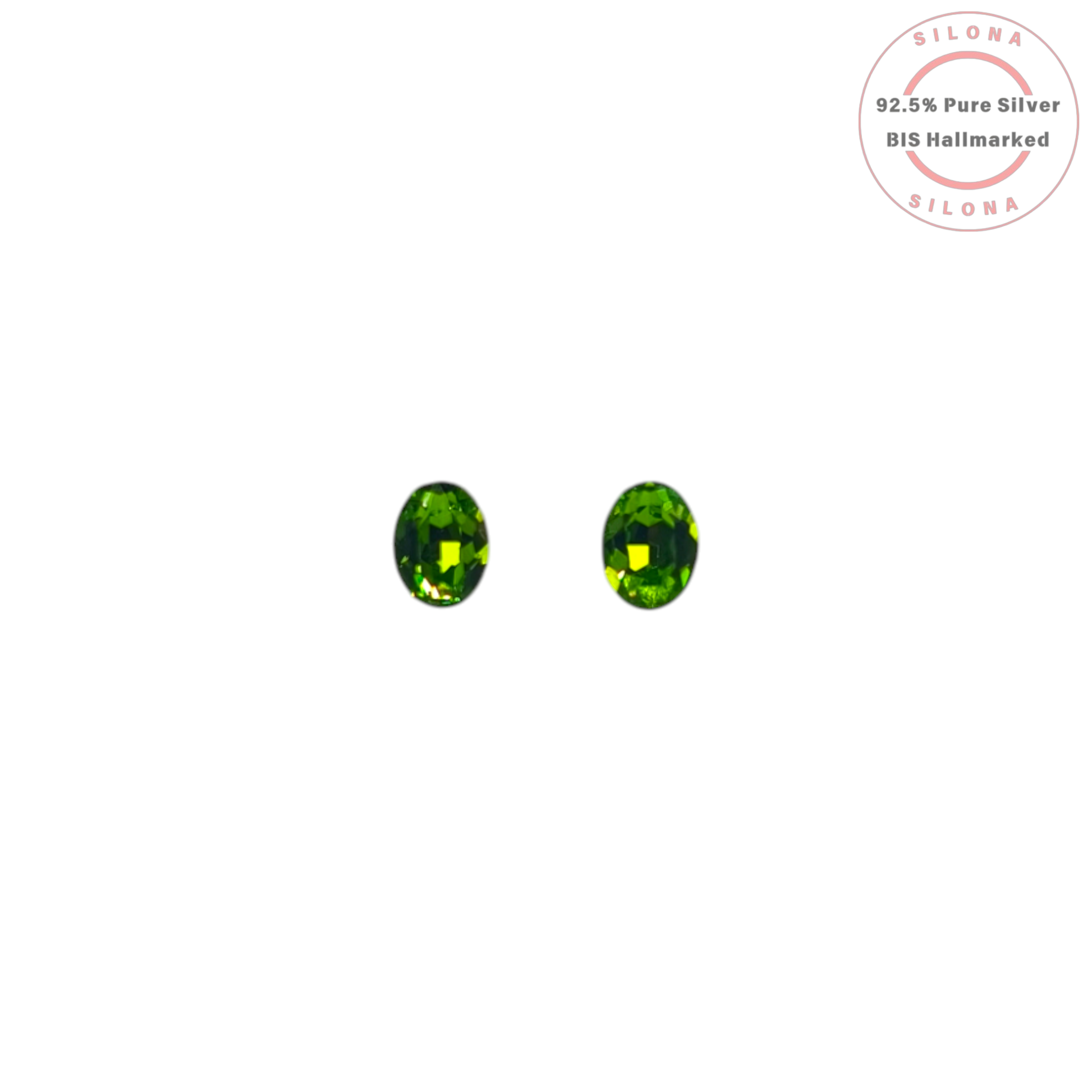 A pair of classic oval-cut stud earrings featuring vibrant peridot-green faceted crystals, set in silver, displayed on a white background with the Silona hallmark.
