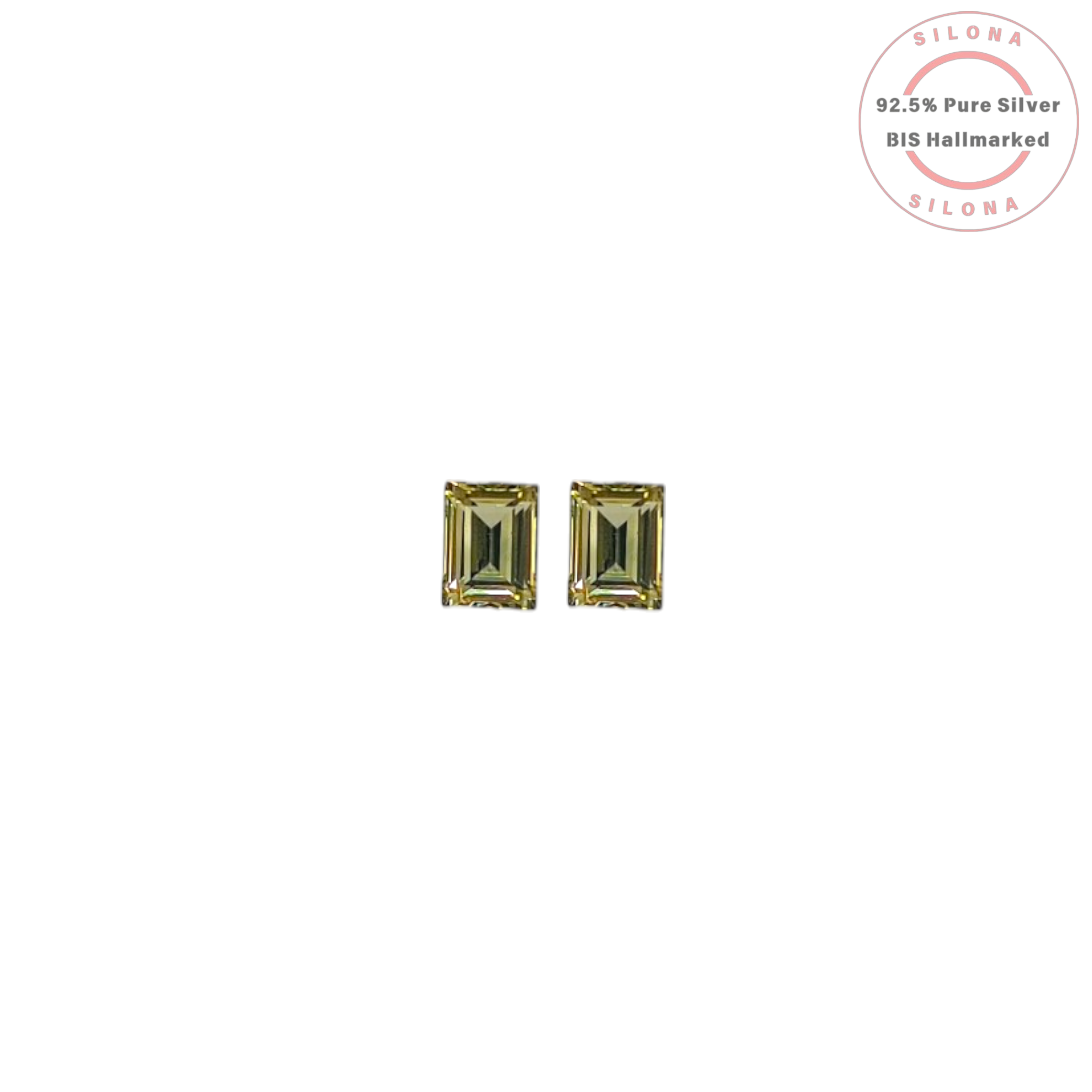 A pair of minimalist emerald-cut stud earrings with a light yellowish-green chartreuse stone, set in 92.5 sterling silver, on a white background.