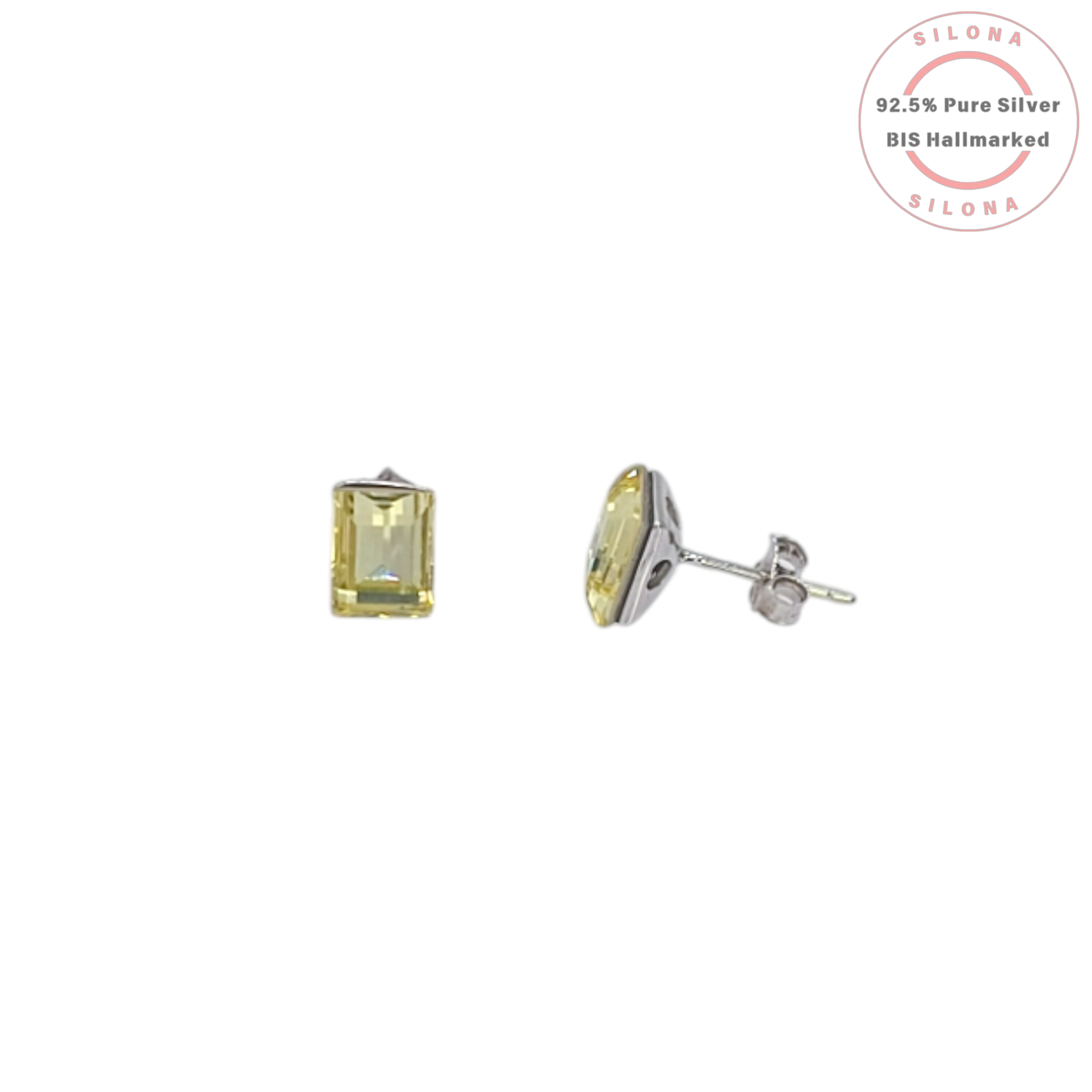 A pair of minimalist emerald-cut stud earrings with a light yellowish-green chartreuse stone, set in 92.5 sterling silver, on a white background.