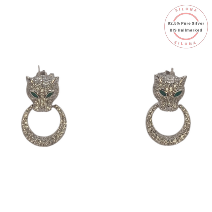 A pair of Silona's Fierce Panther silver earrings, featuring pave cubic zirconia and green stone eyes, on a white background.