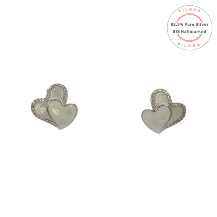 Close-up of the Double Heart stud earrings, part of a set, featuring one Mother of Pearl heart and one pave cubic zirconia heart, crafted in 92.5 silver.
