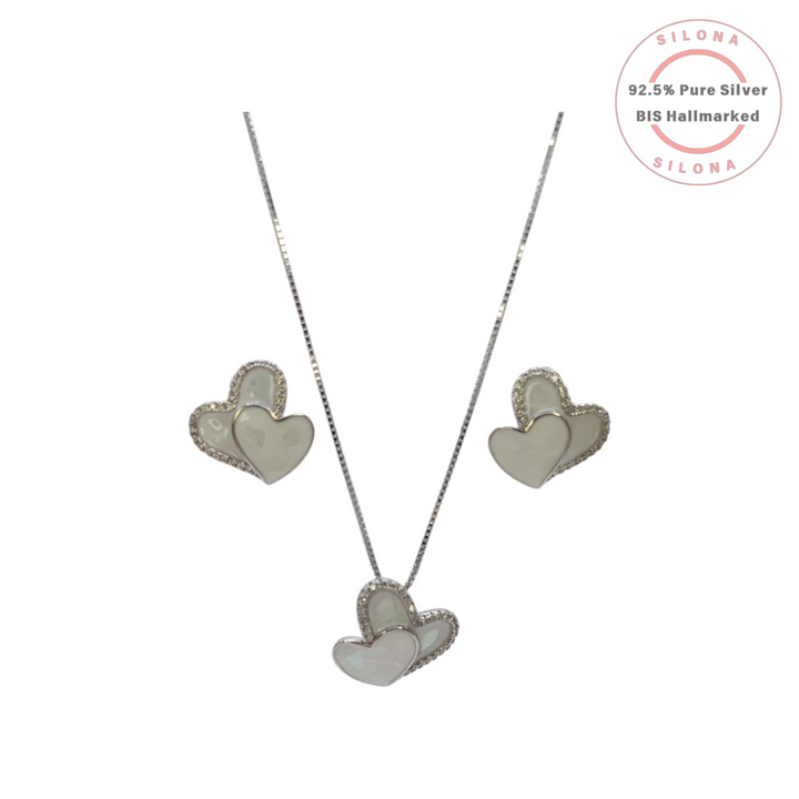 Close-up of the Double Heart stud earrings, part of a set, featuring one Mother of Pearl heart and one pave cubic zirconia heart, crafted in 92.5 silver.