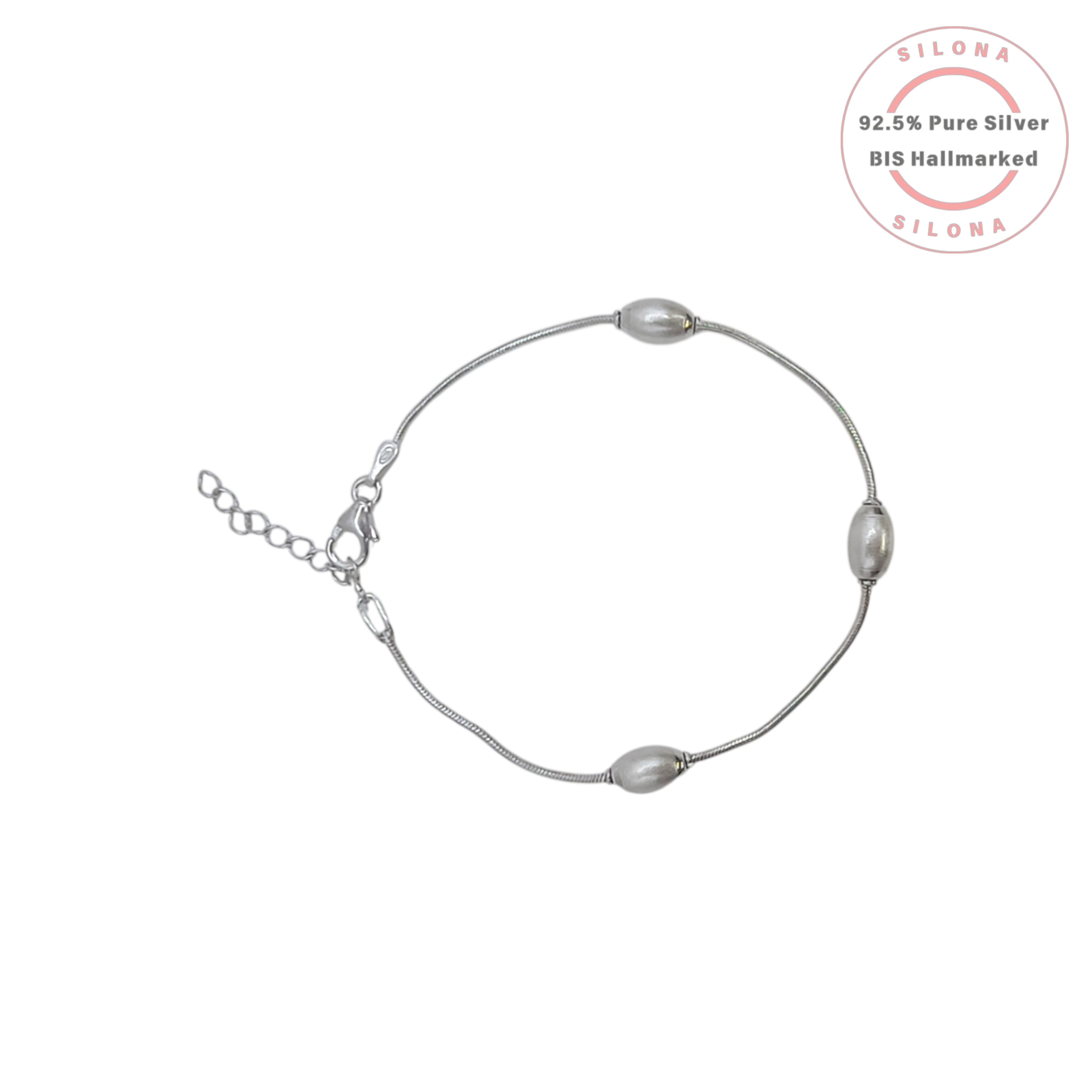 An elegant station bracelet with three rice pearls on a sterling silver snake chain, on a clean white background.