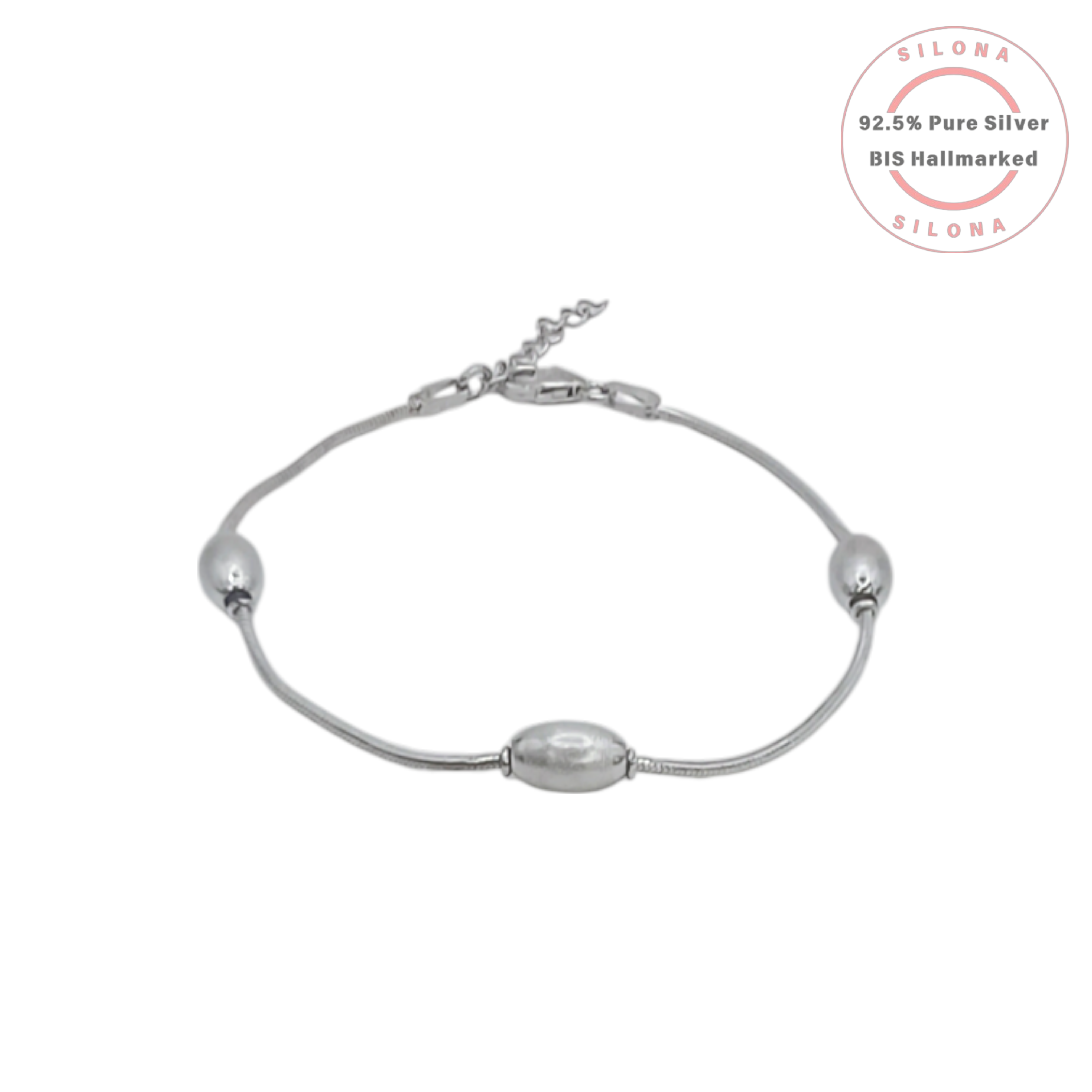 An elegant station bracelet with three rice pearls on a sterling silver snake chain, on a clean white background.