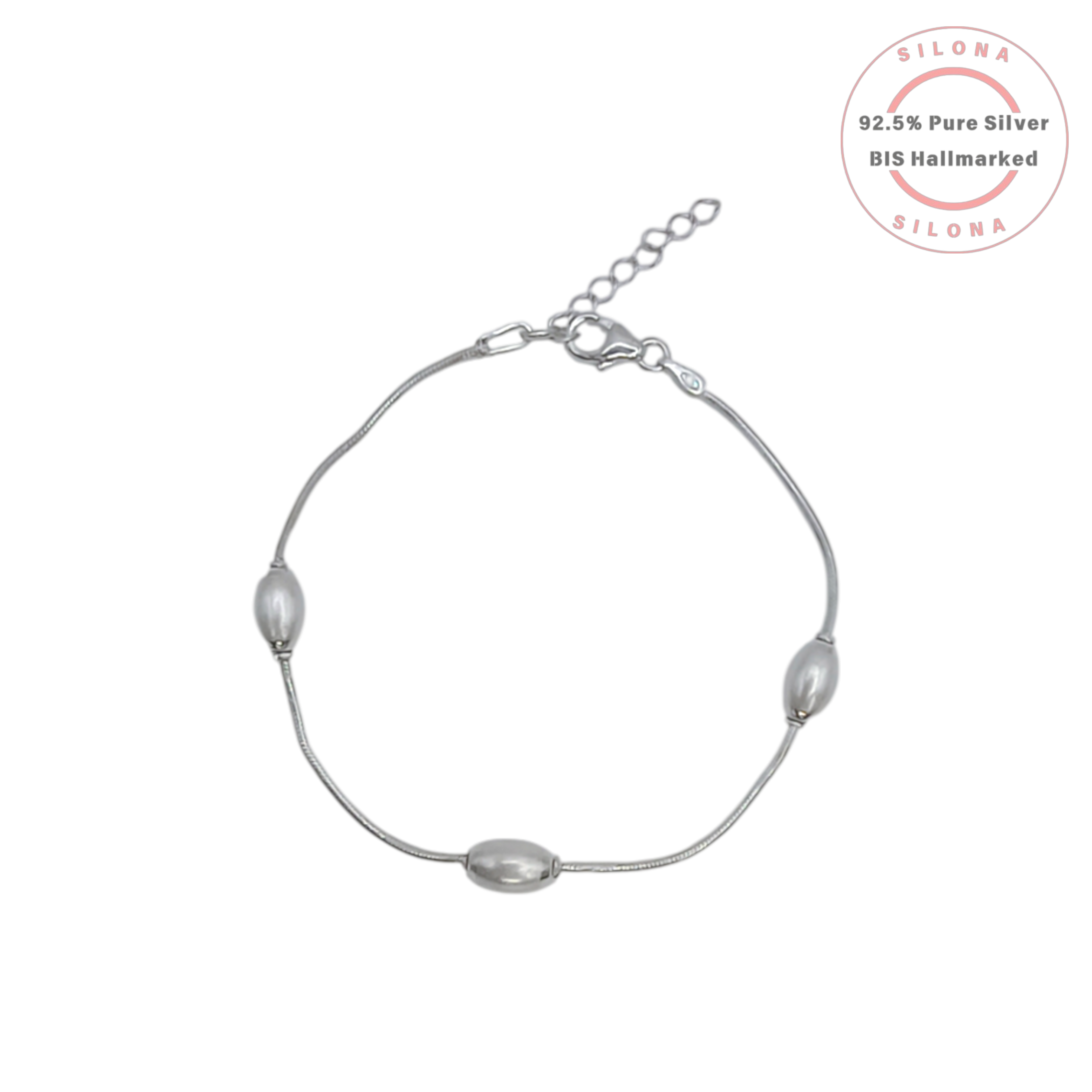An elegant station bracelet with three rice pearls on a sterling silver snake chain, on a clean white background.