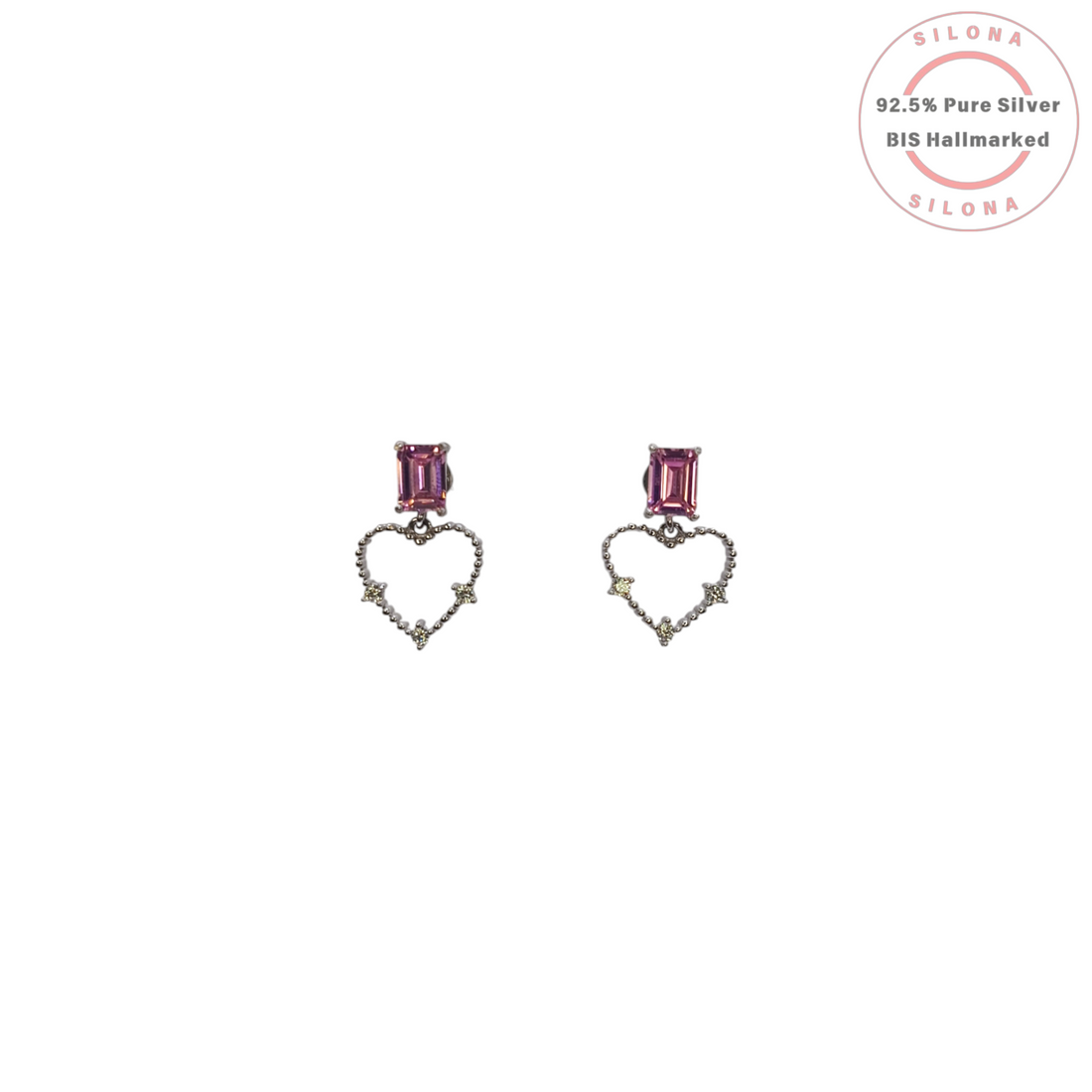 A pair of Silona silver drop earrings featuring a rectangular amethyst-hued stone stud, from which dangles an open-heart silhouette studded with tiny clear gems.