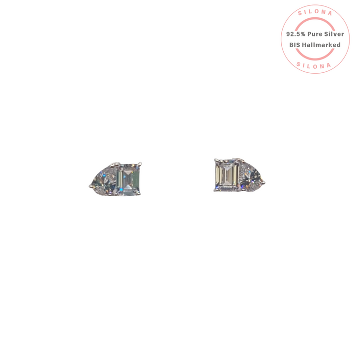 A pair of classic silver stud earrings, each featuring an emerald-cut and a pear-cut cubic zirconia stone on a clean white background.