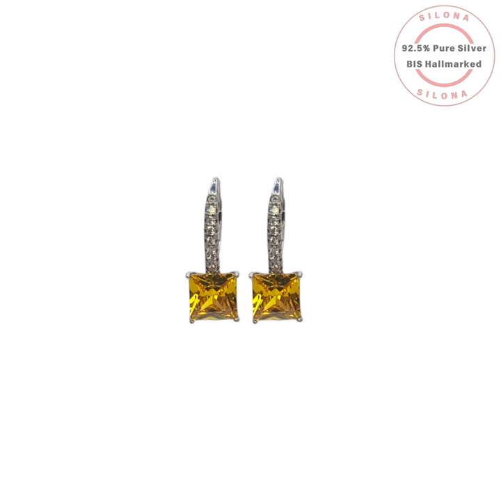 Pair of Radiant Canary Yellow Huggie Drop Earrings in 92.5 silver with pavé-set hoops and a dangling princess-cut yellow stone on a white background.