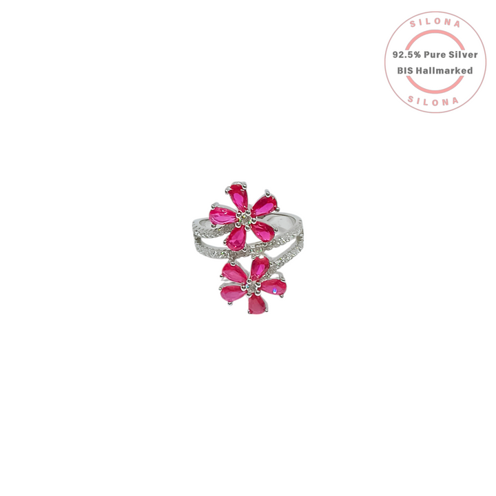 Silona's Double Bloom Floral Ring in 92.5 Silver, featuring two flowers with ruby-pink pear-cut stones and a pavé-set split shank band, on a white background.