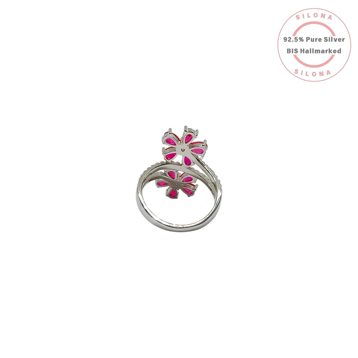 Silona's Double Bloom Floral Ring in 92.5 Silver, featuring two flowers with ruby-pink pear-cut stones and a pavé-set split shank band, on a white background.