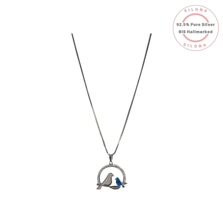 Silona's Sparkling Lovebird Pendant Necklace in 92.5 silver, featuring a pavé cubic zirconia bird beside a smaller cobalt blue enamel bird on a branch.