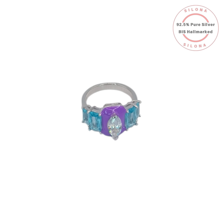 Silona's Vibrant Enamel & Multi-CZ Ring, featuring a purple enamel center with a marquise-cut CZ, flanked by blue baguette-cut stones on a 92.5 silver band.
