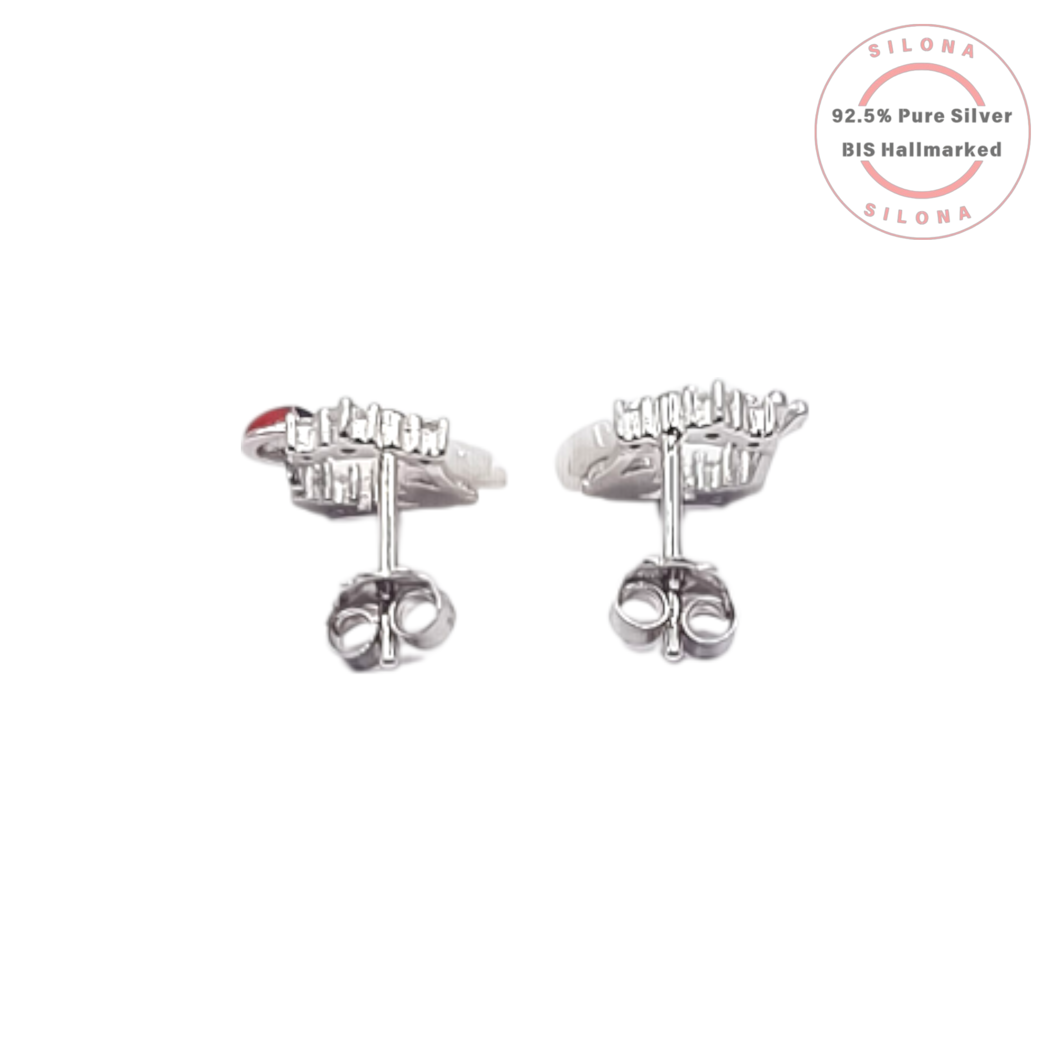 A pair of asymmetrical silver stud earrings, one with a mother-of-pearl flower and the other with a red enamel ladybug, both accented with sparkling cubic zirconia.