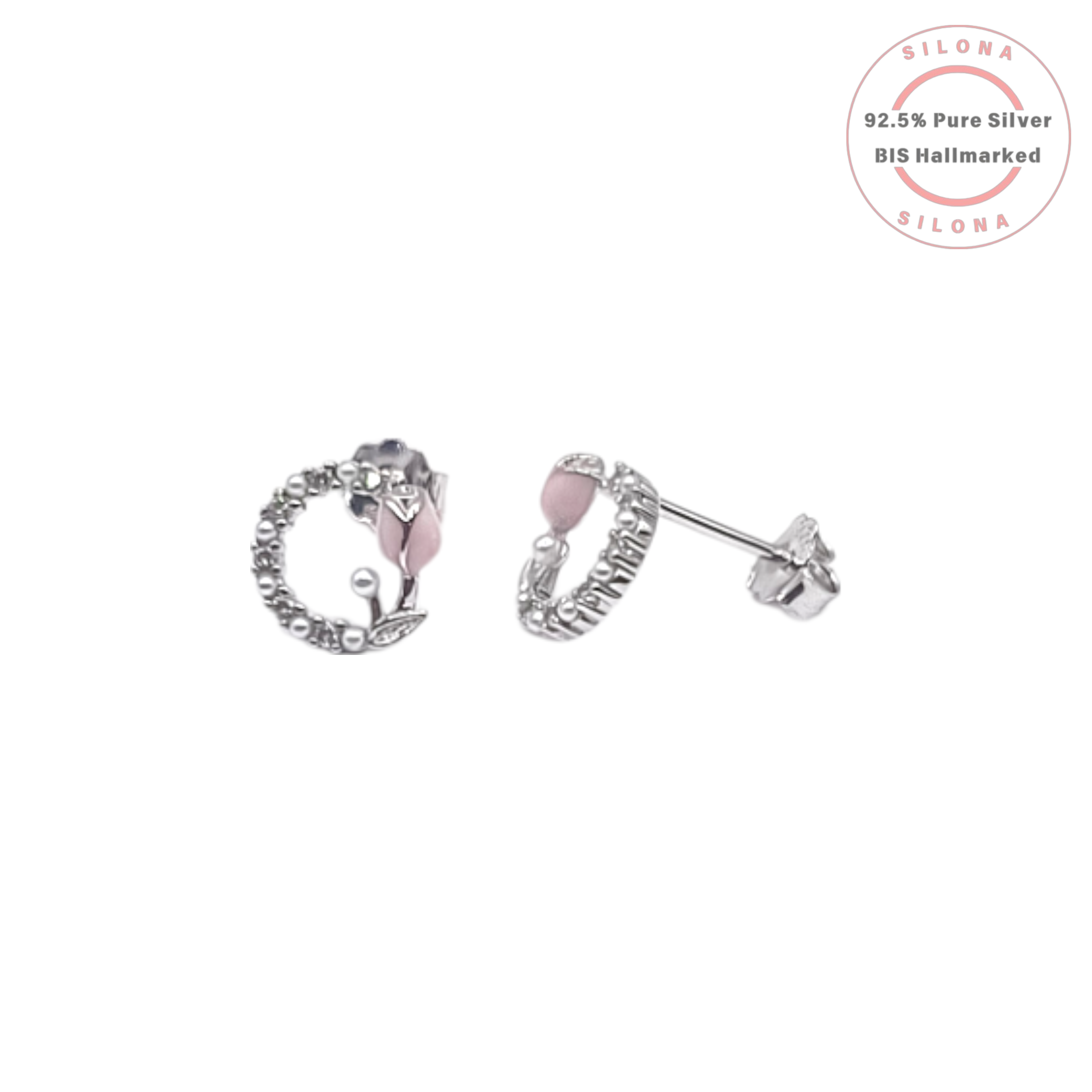 A pair of Silona silver stud earrings featuring a blush-pink enamel tulip inside a wreath of tiny white pearls, on a white background.