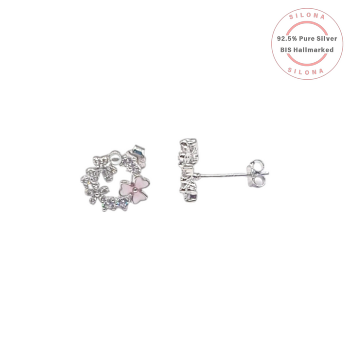 A pair of silver floral wreath stud earrings with pink mother-of-pearl flowers, cubic zirconia, and a small white pearl accent, on a white background.