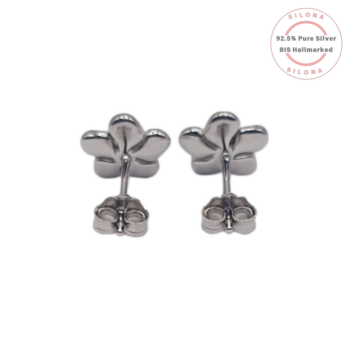 A pair of Silona's silver Plumeria flower stud earrings with soft pink and white enamel petals and a central cubic zirconia, on a white background.