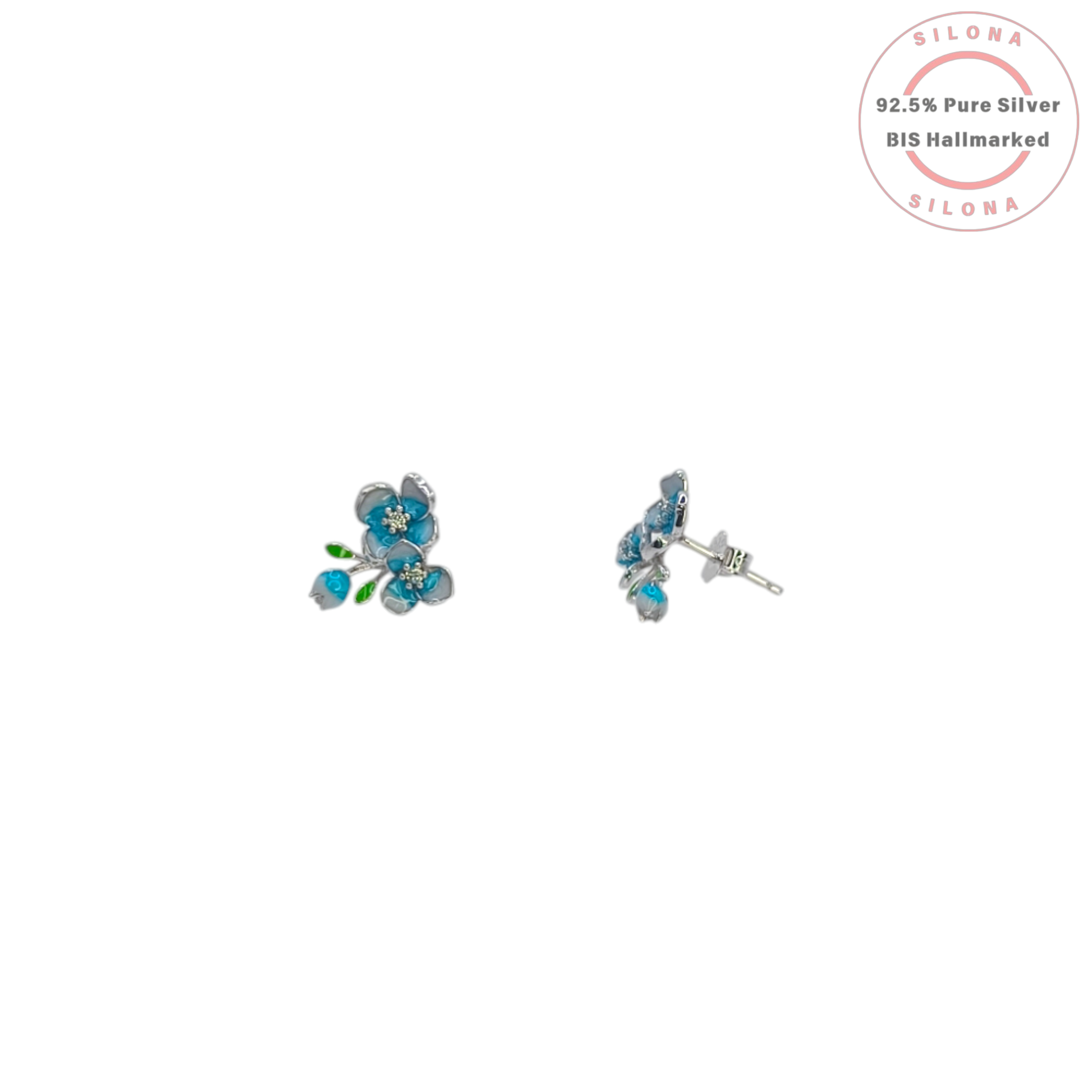 A pair of Silona floral stud earrings crafted in sterling silver, featuring teal and light blue enamel flower petals, green enamel leaves, and a central cluster of sparkling stones.
