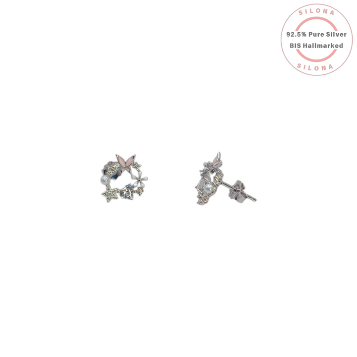A pair of Silona's Enchanted Butterfly Wreath Stud Earrings in 92.5 silver, featuring a pink enamel butterfly, white pearls, and multi-tonal sparkling stones on a white background.