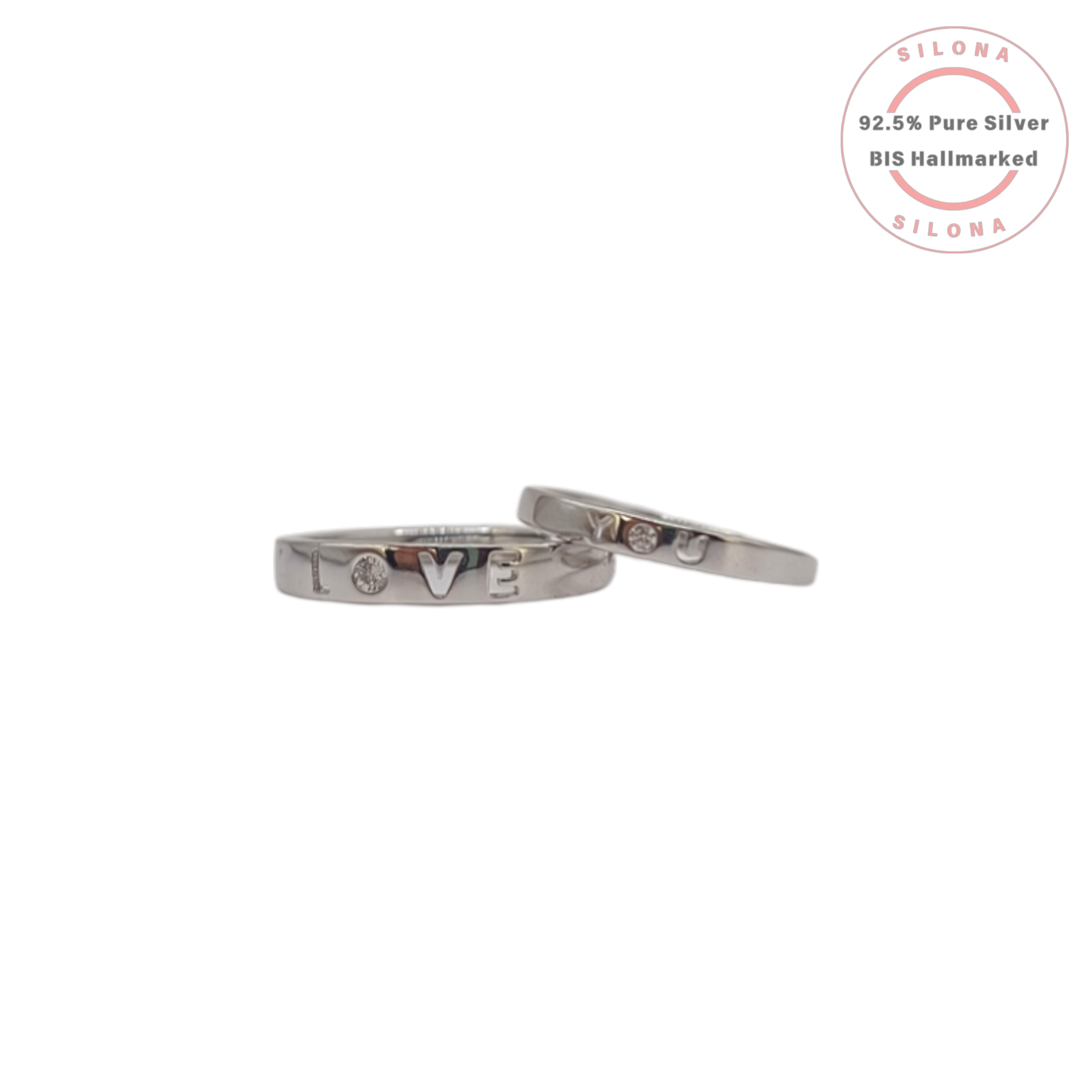 A pair of silver 'Love You' couple's rings, crafted from 92.5 silver with engraved letters and small stone accents, displayed on a white background.