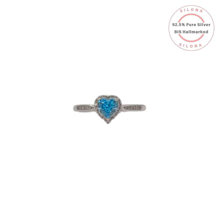 Front view of Silona's Aquamarine Blue Heart Halo Ring in 92.5 silver, featuring a central heart-shaped blue CZ stone surrounded by a halo of white stones.