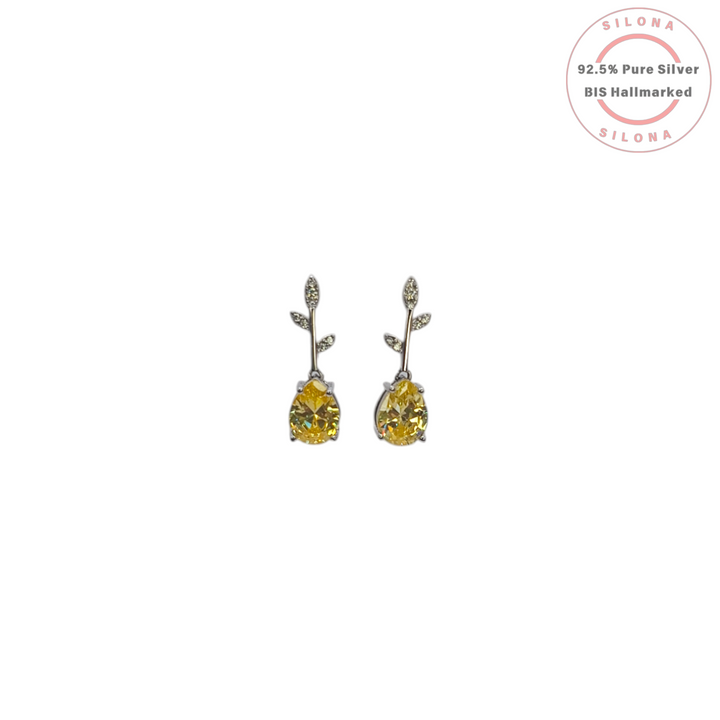 A pair of Silona Canary Vine Drop Earrings in pure 92.5 silver, featuring a pavé leaf stud and a dangling pear-cut yellow cubic zirconia stone on a white background.
