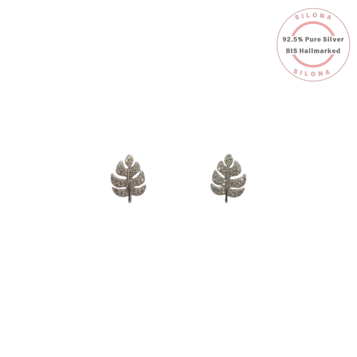 A pair of Silona's Pave Leaf Stud Earrings in 92.5 silver, set with sparkling cubic zirconia, on a white background.