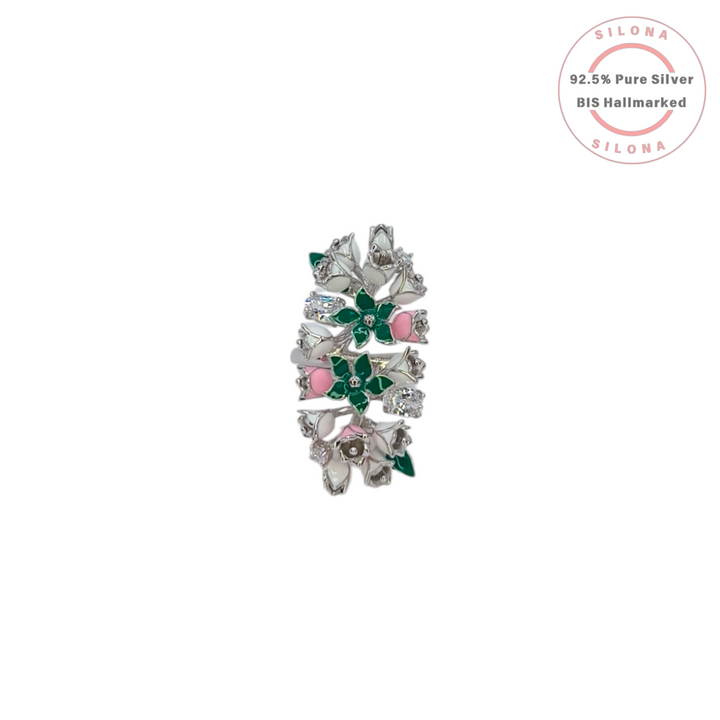 A statement floral ring crafted in 92.5 silver, featuring a cluster of flowers decorated with emerald-green, blush-pink, and white enamel, interspersed with brilliant cubic zirconia.