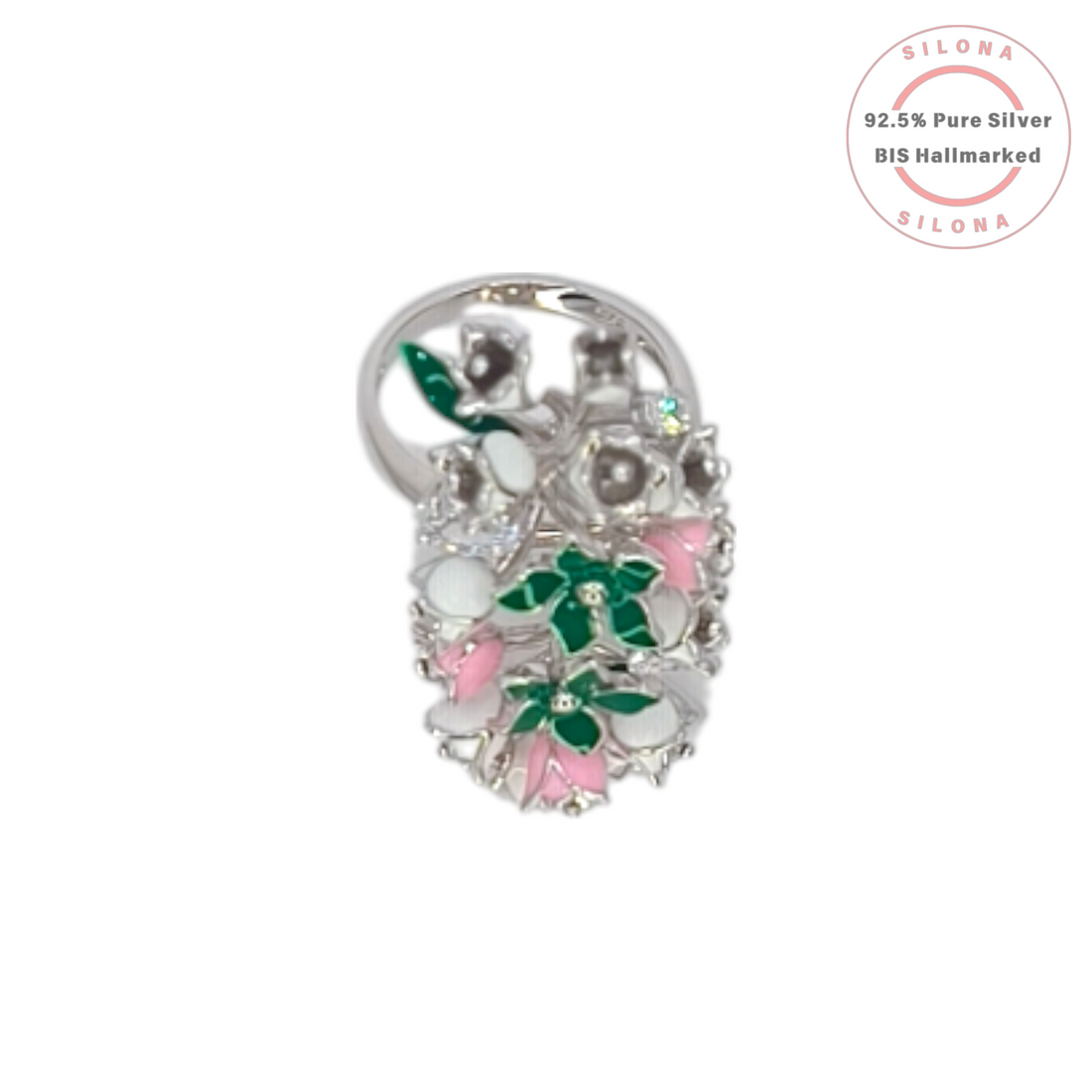 A statement floral ring crafted in 92.5 silver, featuring a cluster of flowers decorated with emerald-green, blush-pink, and white enamel, interspersed with brilliant cubic zirconia.