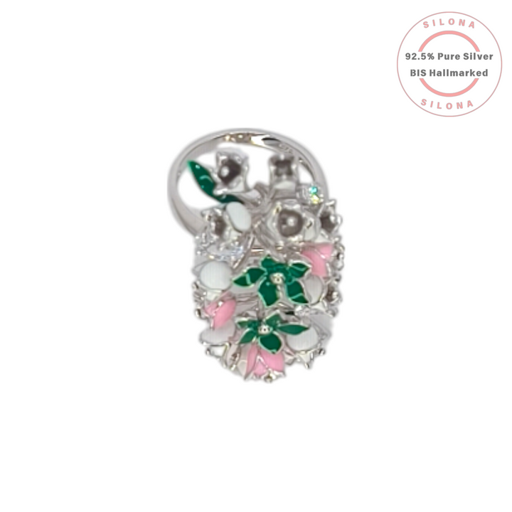 A statement floral ring crafted in 92.5 silver, featuring a cluster of flowers decorated with emerald-green, blush-pink, and white enamel, interspersed with brilliant cubic zirconia.