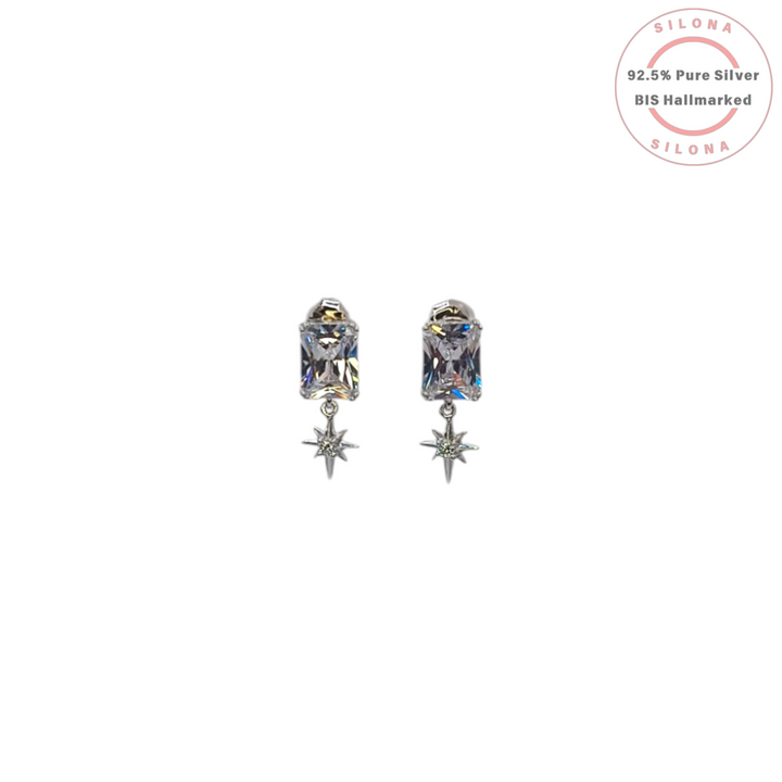 A pair of Silona's Celestial Star Drop Earrings in 92.5 silver, featuring a rectangular cubic zirconia stud with a dangling North Star charm, on a white background.