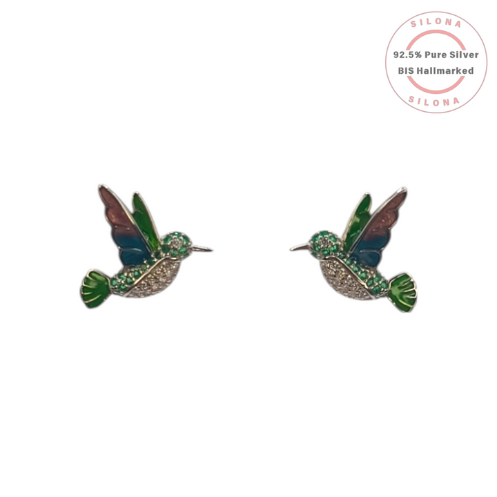A pair of silver hummingbird stud earrings with multi-color enamel wings and sparkling cubic zirconia, set against a white background.