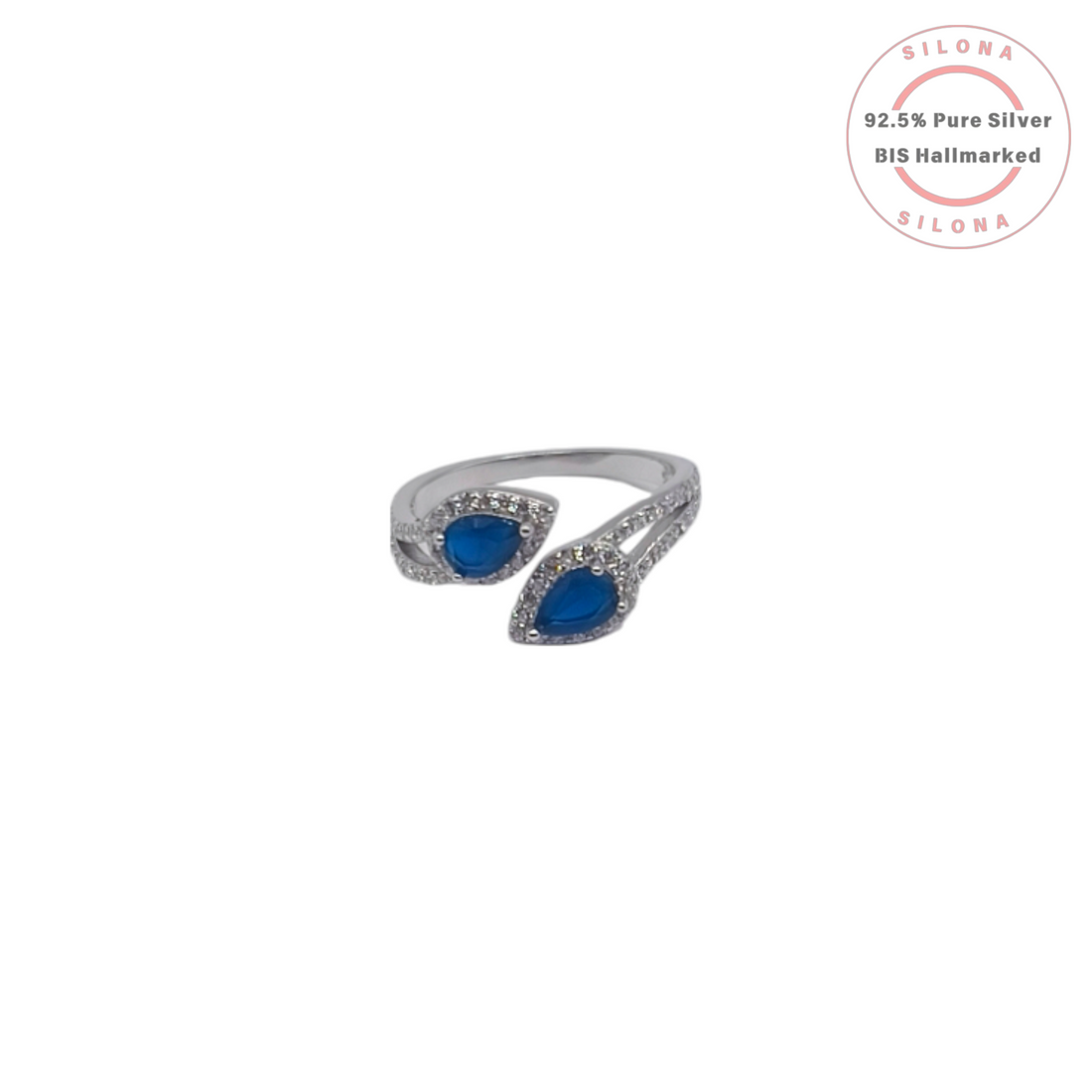 Silona Crossover Ring in 92.5 silver, featuring two pear-shaped sapphire-blue stones and a pavé band.