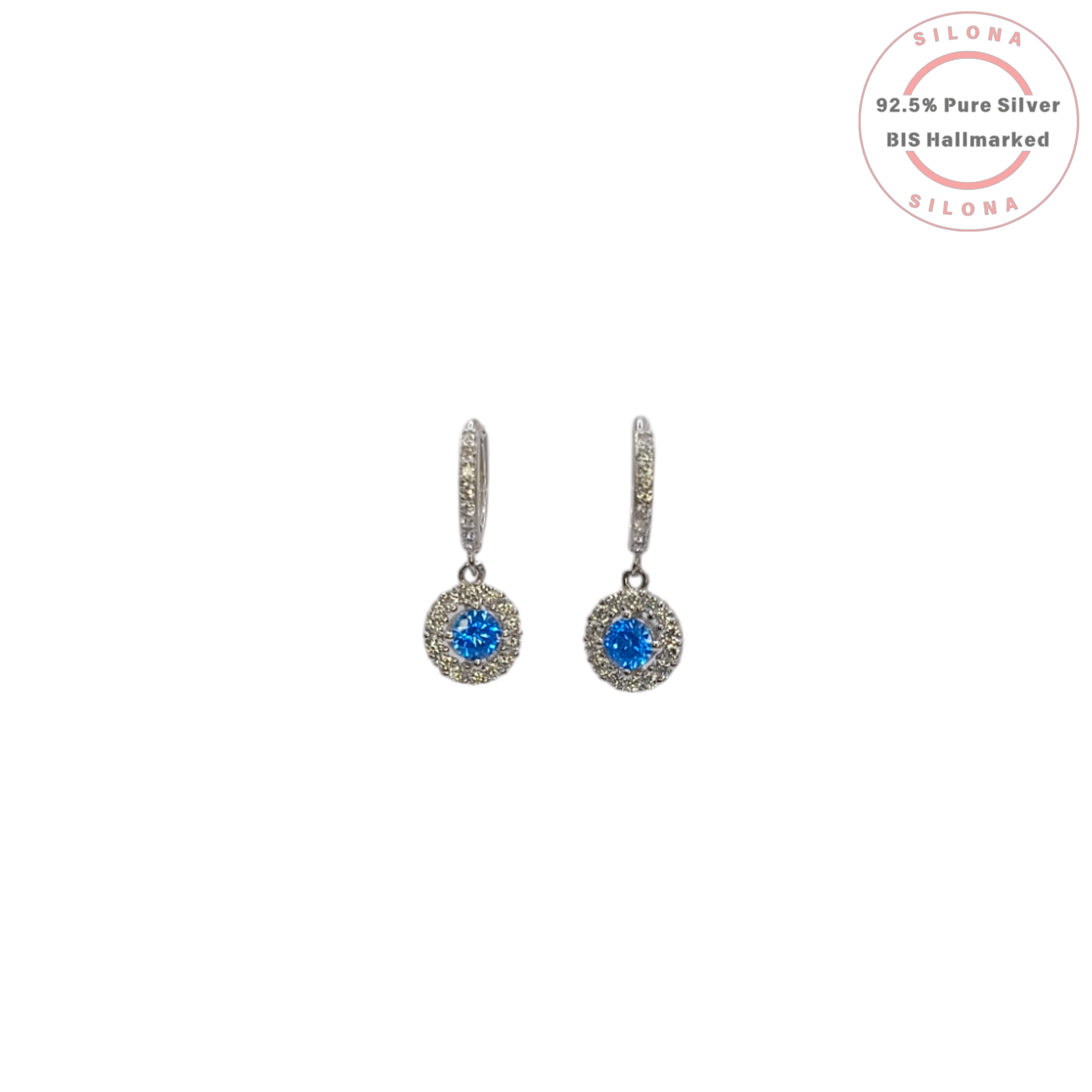 A pair of silver halo dangler earrings featuring a central round Swiss blue cubic zirconia, hanging from a pavé-set huggie hoop, against a clean white background.