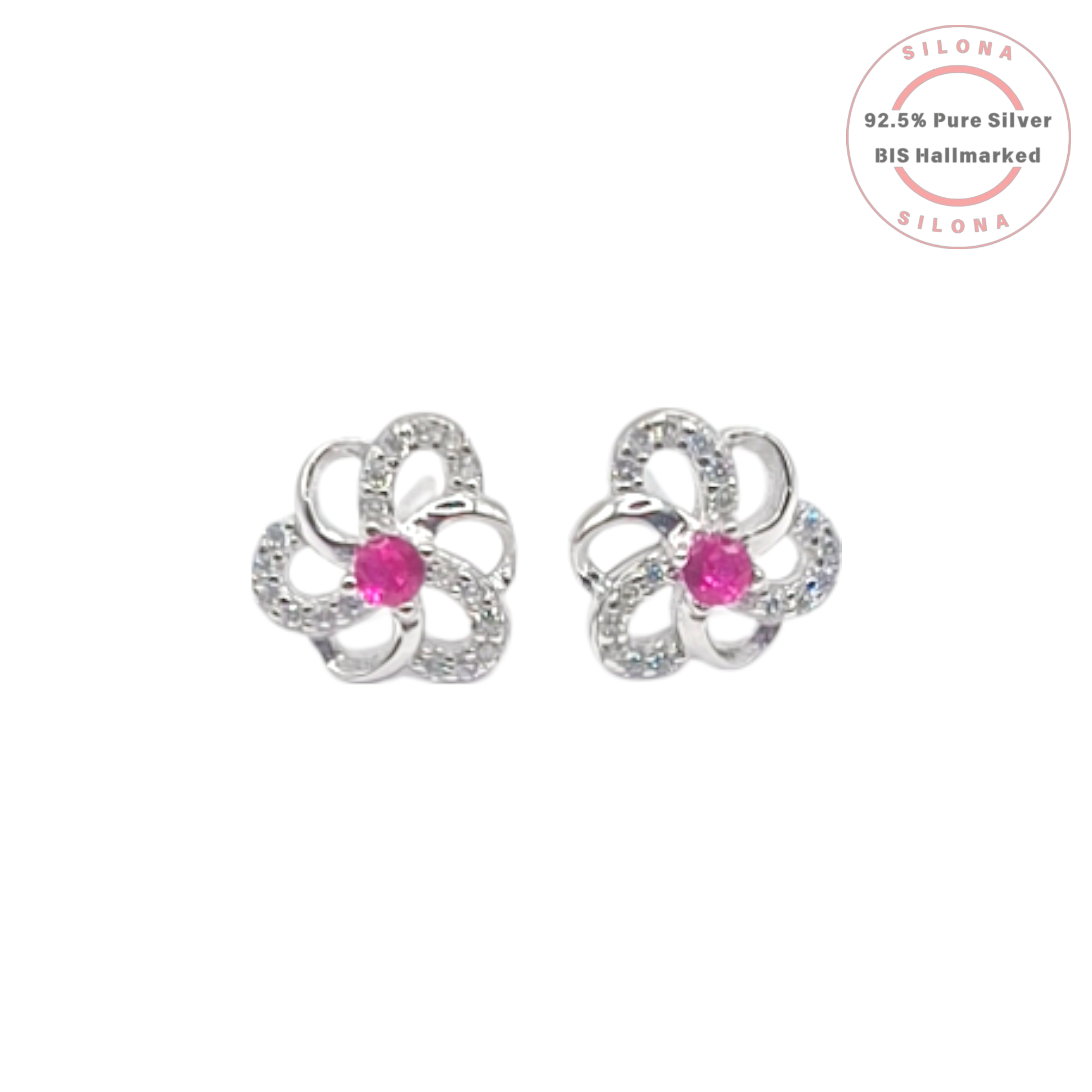 A pair of Silona silver floral stud earrings, each with a central ruby-pink stone and petals paved with clear cubic zirconia, on a white background.
