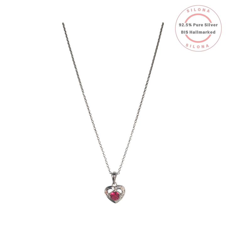 Silona's Sparkling Ruby Red Heart Necklace in 92.5 silver, featuring an open-heart pendant with a central red stone and pavé cubic zirconia, on a white background.