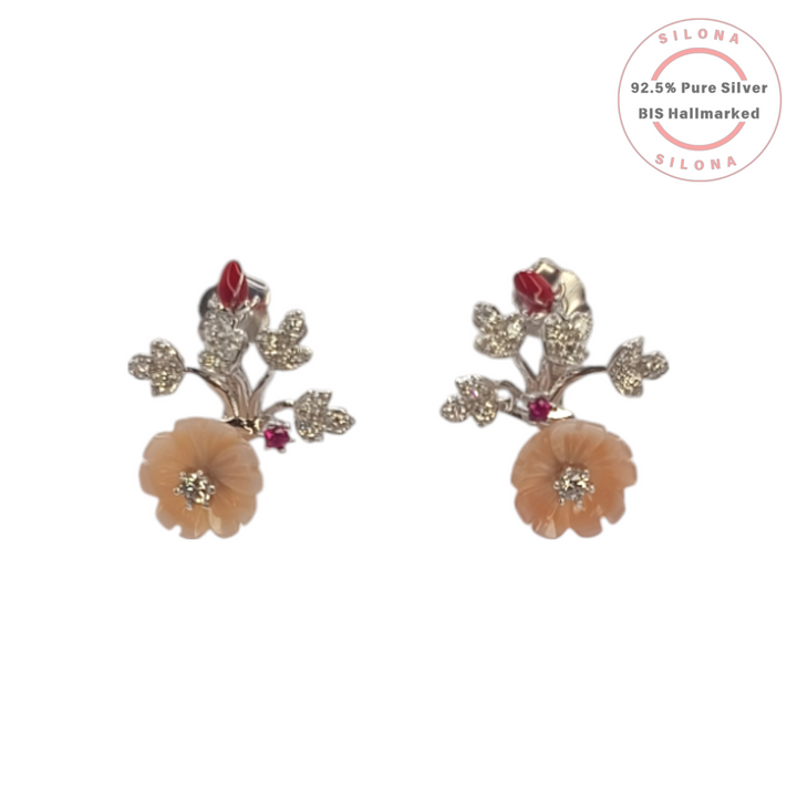 A pair of Silona floral stud earrings in 92.5 silver, featuring a carved peach mother-of-pearl flower, a sparkling cubic zirconia vine, and red enamel details, on a white background.