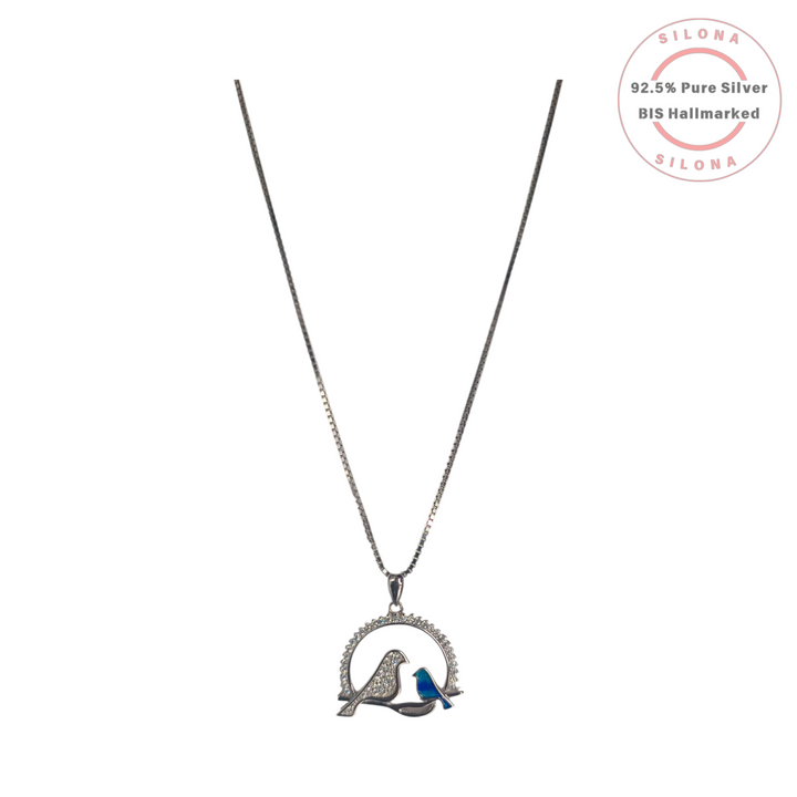 Silona Lovebird Duo Necklace in 92.5 sterling silver, featuring a pavé Cubic Zirconia bird and a blue enamel bird on a branch, with a silver box chain.