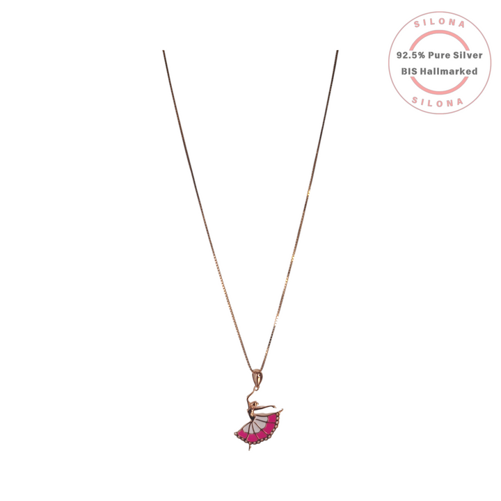 A rose gold plated silver necklace with a delicate box chain and a ballerina pendant. The ballerina's skirt is decorated with fuchsia pink and white enamel.