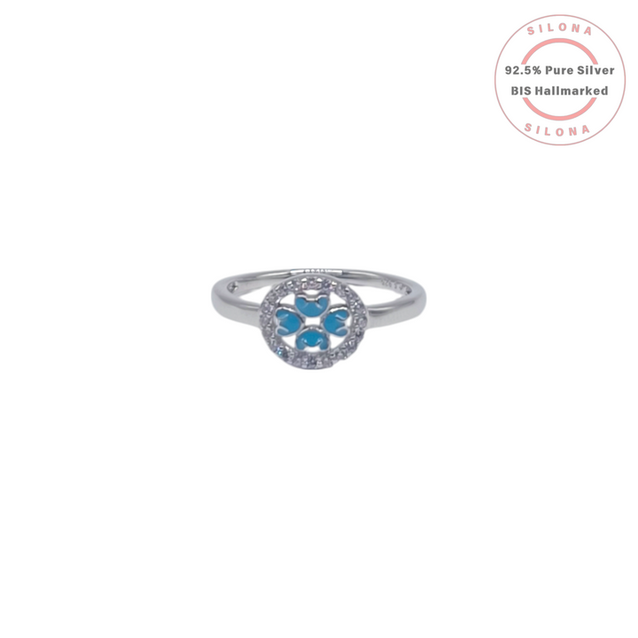Silona's Azure Clover Halo Ring in 92.5 silver, featuring a four-leaf clover motif with azure blue enamel, surrounded by a halo of cubic zirconia, on a white background.