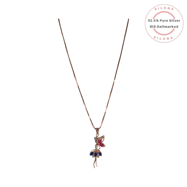 A rose gold plated Ballerina Pendant Necklace made from 92.5 silver, with a dancer motif featuring sapphire and ruby-hued cubic zirconia stones, on a white background.