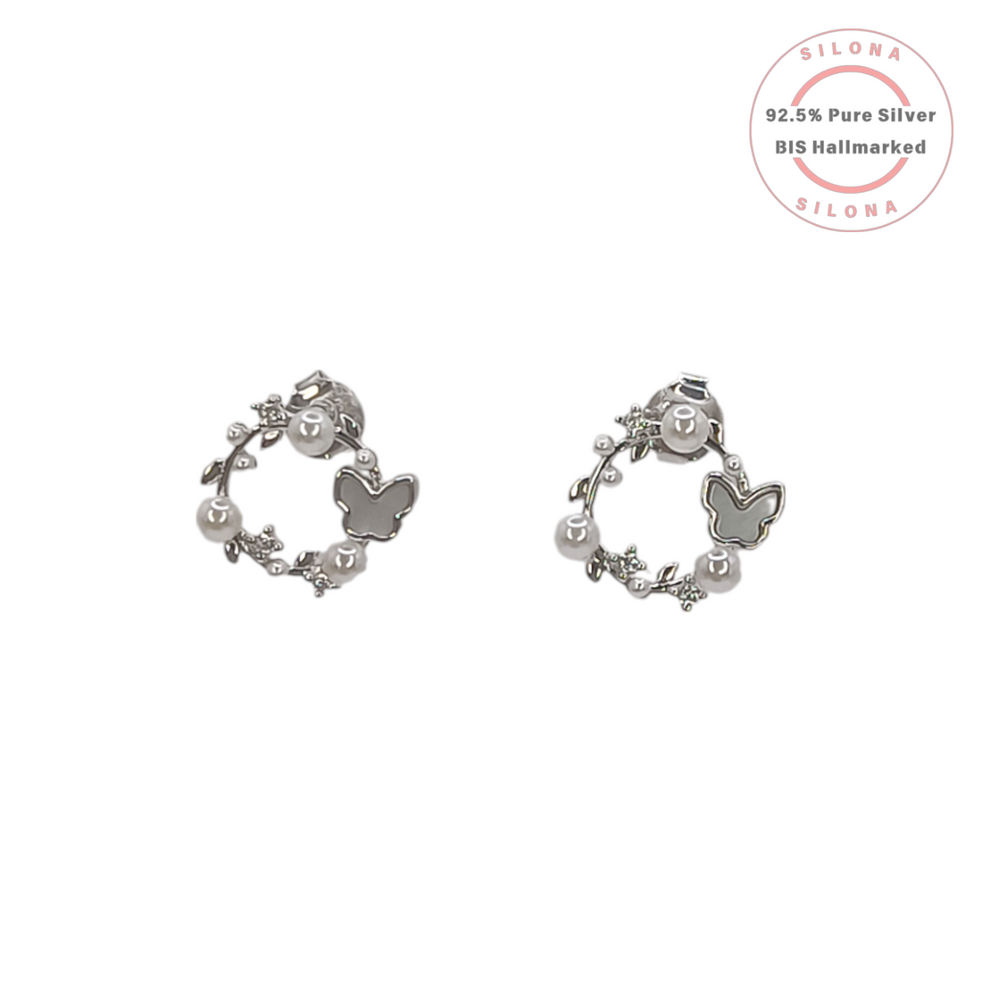 A pair of Silona's Ethereal Butterfly Wreath Earrings in 92.5 silver, featuring a mother-of-pearl butterfly, white pearls, and crystal leaves on a white background.