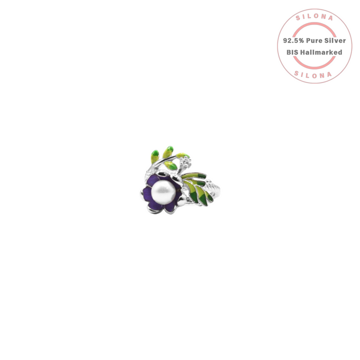 Silona's Enamel Blossom Ring, crafted in 92.5 silver, featuring a purple enamel flower with a central pearl and vibrant green enamel leaves.