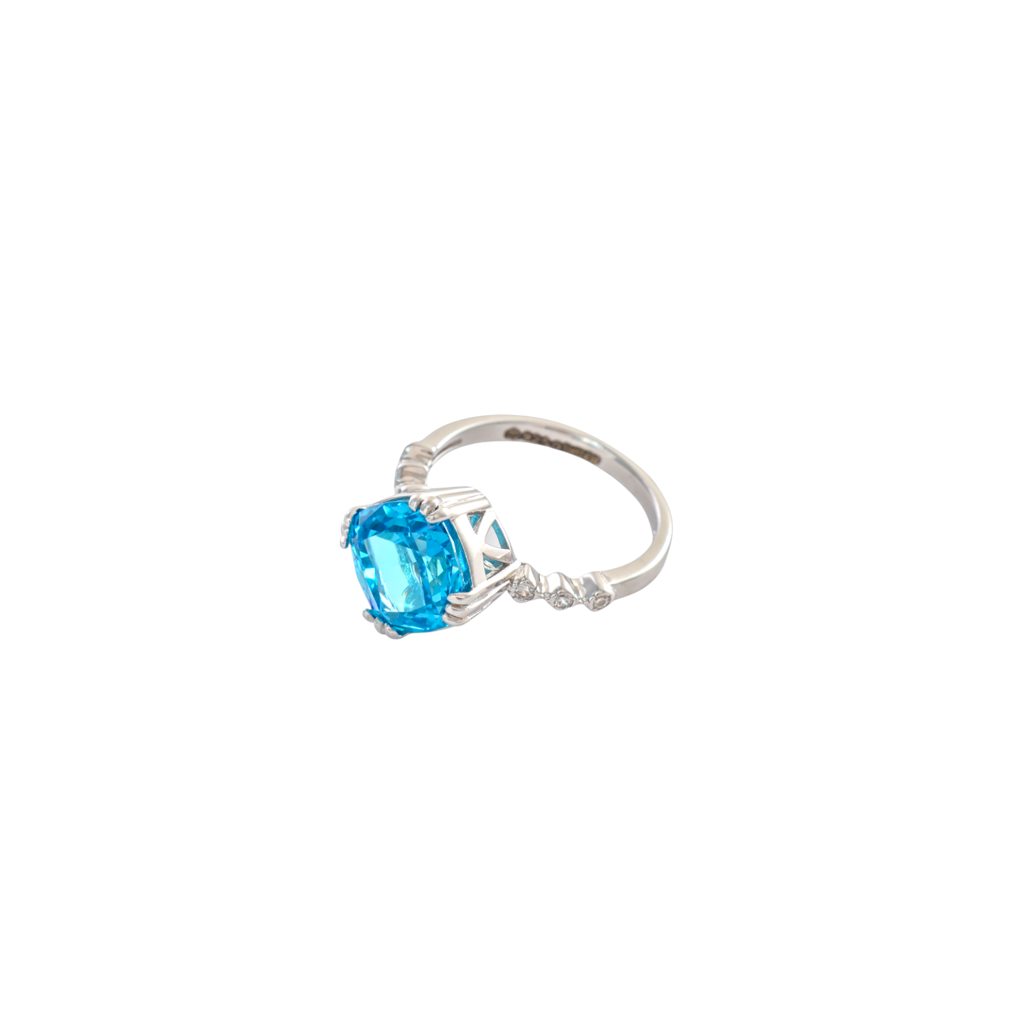 Bright electric blue cushion cut gemstone set in silver with a delicate accent band.