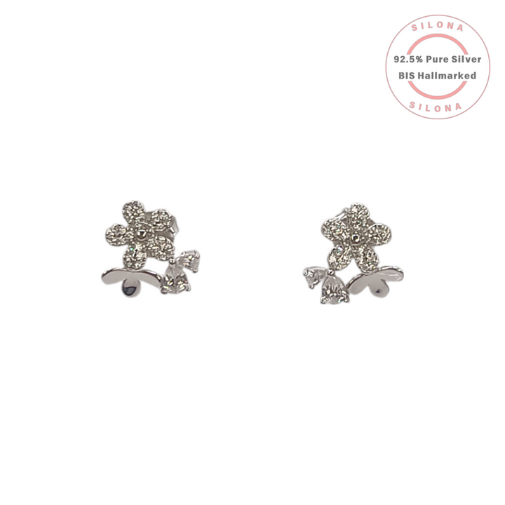A pair of silver floral stud earrings, paved with brilliant cubic zirconia stones, on a clean white background.