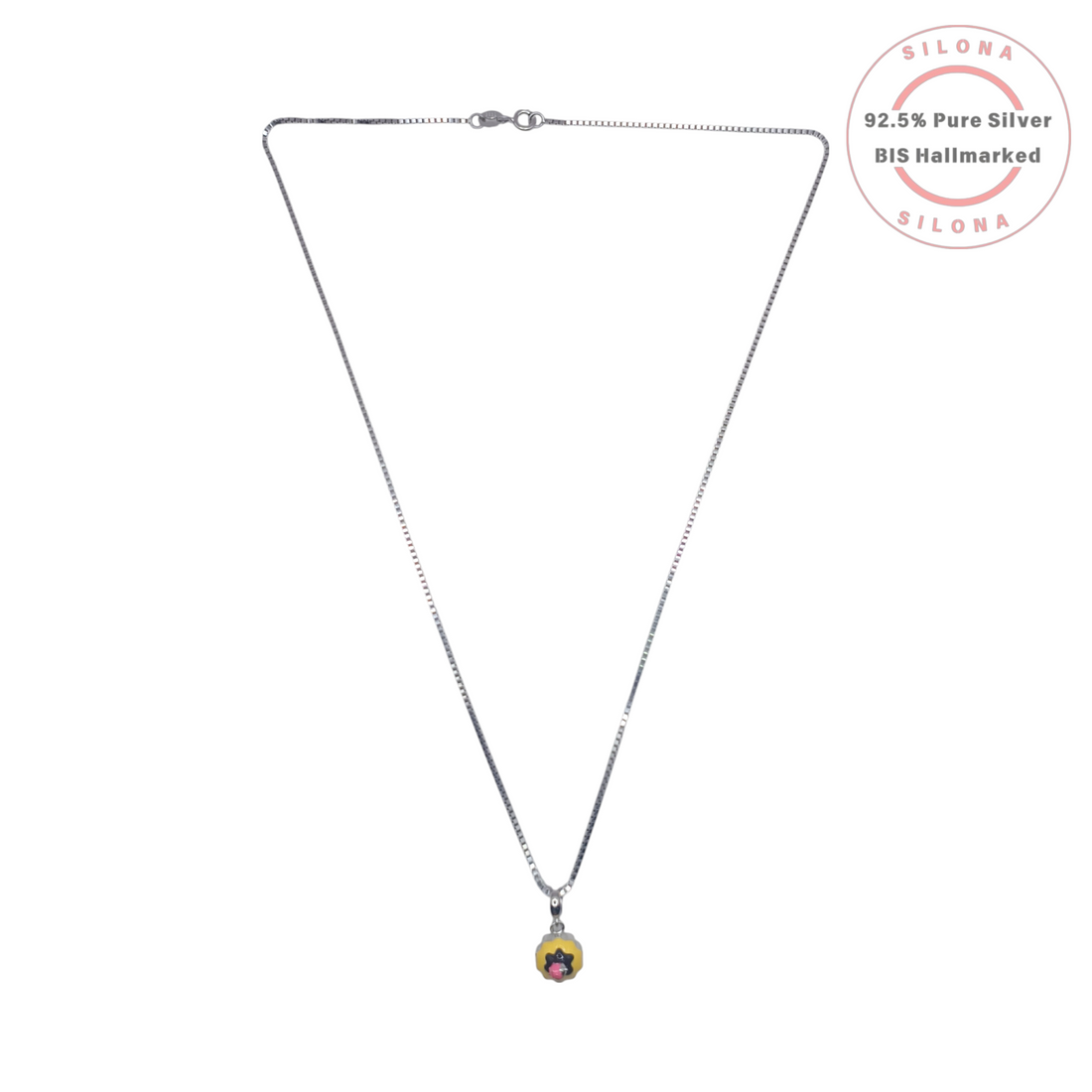 A minimalist silver box chain necklace featuring a small, round yellow enamel charm with a black and pink pop art floral design, on a white background.