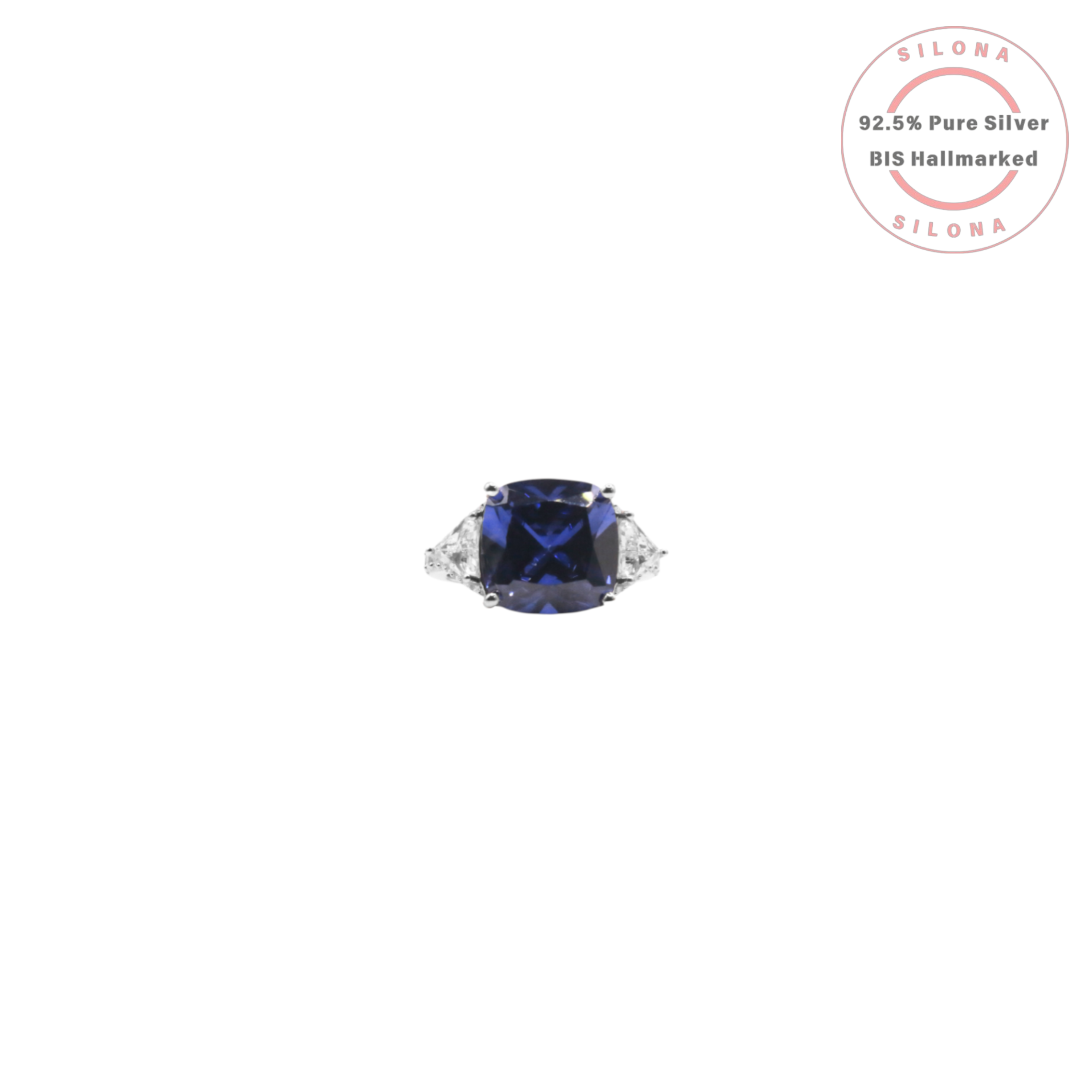 A classic three-stone silver ring featuring a large, cushion-cut, sapphire-blue center stone and two trillion-cut side stones on a white background.